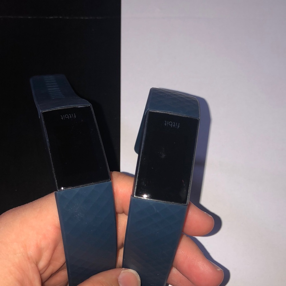two dark blue fit bit charge 4